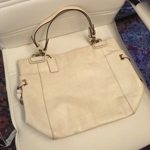 Cream, glossy patent leather Coach shoulder bag